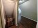 The hallway has wood floors and connects rooms, as well as a staircase to the basement at 802 Fern Dr, Shelbyville, IN 46176
