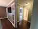 Inviting hallway showcasing hardwood floors and access to a bedroom and bathroom at 802 Fern Dr, Shelbyville, IN 46176