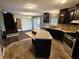 A kitchen with dark cabinets, an island, stainless steel appliances, and a neutral backsplash at 802 Fern Dr, Shelbyville, IN 46176