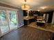 Modern kitchen with dark cabinetry, stainless steel appliances, and sliding glass door access to the backyard deck at 802 Fern Dr, Shelbyville, IN 46176