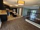 Open kitchen with black cabinets, stainless steel appliances, and an island open to another room at 802 Fern Dr, Shelbyville, IN 46176