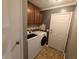 Well-equipped laundry room with modern appliances, cabinet storage, and tile flooring at 802 Fern Dr, Shelbyville, IN 46176