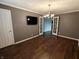 Spacious living room featuring hardwood floors, TV, French doors, and ample room to relax at 802 Fern Dr, Shelbyville, IN 46176