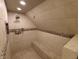 Tiled shower stall with bench, shower head, body spray, and mosaic tile accent at 802 Fern Dr, Shelbyville, IN 46176