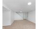 Spacious basement featuring plush carpeting, white walls, and access to an additional room at 8205 Picadilly Ln, Indianapolis, IN 46256