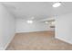 Spacious basement featuring neutral carpet, bright lighting, and a convenient wet bar area at 8205 Picadilly Ln, Indianapolis, IN 46256