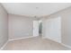 Spacious bedroom featuring neutral walls, plush carpeting, and a double closet for storage at 8205 Picadilly Ln, Indianapolis, IN 46256