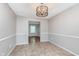 Dining area with tile flooring, wainscoting, and decorative lighting fixture at 8205 Picadilly Ln, Indianapolis, IN 46256