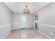 The dining room has tile floors and stylish lighting near the kitchen and a back entrance at 8205 Picadilly Ln, Indianapolis, IN 46256