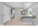 Open-concept space with a tiled floor that connects the kitchen and breakfast bar at 8205 Picadilly Ln, Indianapolis, IN 46256