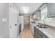 This eat-in kitchen features a window with a view, stainless steel sink, and stylish tiled floors at 8205 Picadilly Ln, Indianapolis, IN 46256