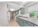 A sunlit kitchen with green cabinets, tile floors, and white appliances at 8205 Picadilly Ln, Indianapolis, IN 46256