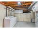 Functional laundry room with washer, dryer, and exposed ceiling at 8205 Picadilly Ln, Indianapolis, IN 46256