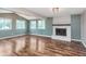 This open-concept living room features a vaulted ceiling, fireplace, and many windows at 8205 Picadilly Ln, Indianapolis, IN 46256