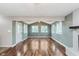 Bright open-concept living room features a fireplace, hardwood floors, and lots of natural light at 8205 Picadilly Ln, Indianapolis, IN 46256