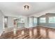 This open-concept living room has hardwood floors, a door to the outside, and view to kitchen at 8205 Picadilly Ln, Indianapolis, IN 46256