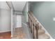 Carpeted staircase featuring white trim, muted green walls, and access to the upper level at 8205 Picadilly Ln, Indianapolis, IN 46256