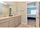 Bright bathroom with double sinks, granite countertops, and entry view to the nearby bedroom at 925 Bent Branch Cir, Greenwood, IN 46143