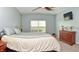 This bedroom has plush bedding, a ceiling fan, and a mounted TV for comfort and relaxation at 925 Bent Branch Cir, Greenwood, IN 46143
