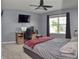 This gray bedroom features a ceiling fan, window views, and a study area for relaxation and productivity at 925 Bent Branch Cir, Greenwood, IN 46143