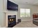 Stylish living room features a fireplace, large TV, and ample seating, perfect for relaxing and entertaining guests at 925 Bent Branch Cir, Greenwood, IN 46143