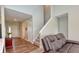 Inviting living room featuring a high ceiling, wood floors, and staircase, perfect for relaxation and entertaining at 925 Bent Branch Cir, Greenwood, IN 46143