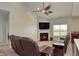Cozy living room features a fireplace, large TV, and comfortable seating for a relaxing and enjoyable atmosphere at 925 Bent Branch Cir, Greenwood, IN 46143