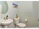 Clean powder room features a pedestal sink, toilet and accent painting at 925 Bent Branch Cir, Greenwood, IN 46143