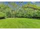 Lush backyard with mature trees offering shade and a swing at 9698 Coyote Ct, Noblesville, IN 46060