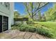 Backyard featuring a stone patio, garden beds, and a lush lawn at 9698 Coyote Ct, Noblesville, IN 46060