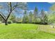 Expansive backyard with lush green lawn and mature trees offers plenty of space for outdoor activities and relaxation at 9698 Coyote Ct, Noblesville, IN 46060
