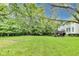 Well-maintained backyard featuring a spacious lawn, mature trees, and a deck, perfect for outdoor entertaining and leisure at 9698 Coyote Ct, Noblesville, IN 46060