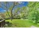 Expansive backyard with lush green grass, mature trees, and room for outdoor activities at 9698 Coyote Ct, Noblesville, IN 46060