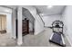 Partially finished basement featuring a carpeted area, exercise equipment, and a staircase at 9698 Coyote Ct, Noblesville, IN 46060