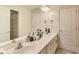 Bathroom featuring a double sink vanity, a large mirror, and doorways to adjacent rooms at 9698 Coyote Ct, Noblesville, IN 46060