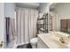 Cozy bathroom featuring neutral tones, a shower with a decorative curtain, and ample storage at 9698 Coyote Ct, Noblesville, IN 46060