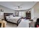 Bedroom with ceiling fan, large bed, and window with natural light at 9698 Coyote Ct, Noblesville, IN 46060