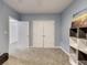 This blue-walled bedroom features carpeted floors, a double closet, and a shelf unit at 9698 Coyote Ct, Noblesville, IN 46060