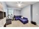 Cozy bedroom with carpeted floors, a ceiling fan, and comfortable blue convertible couch at 9698 Coyote Ct, Noblesville, IN 46060