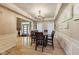 Bright dining room featuring hardwood floors, modern chandelier, and a view into the home's entry at 9698 Coyote Ct, Noblesville, IN 46060