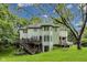 The back of the house features a deck and staircase, overlooking a spacious lawn and mature trees at 9698 Coyote Ct, Noblesville, IN 46060