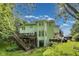 Back of house with large deck, overlooking a spacious lawn and mature trees at 9698 Coyote Ct, Noblesville, IN 46060