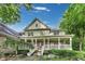 Charming two-story home with a welcoming front porch, lush landscaping, and a well-maintained exterior exudes curb appeal at 9698 Coyote Ct, Noblesville, IN 46060