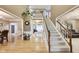 Grand foyer with a staircase, hardwood floors, and an open view to the living spaces, creating an inviting entrance at 9698 Coyote Ct, Noblesville, IN 46060