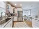Well-lit kitchen with stainless steel appliances, granite counters, backsplash, and eat-in breakfast nook area at 9698 Coyote Ct, Noblesville, IN 46060