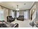 Well-lit living room featuring comfortable leather seating, white curtains, and a neutral color palette, perfect for relaxation at 9698 Coyote Ct, Noblesville, IN 46060