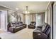 Comfortable living room with plush leather furniture, large windows, and elegant curtains, creating a cozy atmosphere at 9698 Coyote Ct, Noblesville, IN 46060