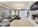 Spacious living room features a large sectional sofa, fireplace, and large windows offering natural light at 9698 Coyote Ct, Noblesville, IN 46060