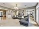 Spacious living room with plush carpeting, recessed lights, and a view of an updated kitchen at 9698 Coyote Ct, Noblesville, IN 46060