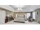 This spacious main bedroom has a tray ceiling and a seating area at 9698 Coyote Ct, Noblesville, IN 46060